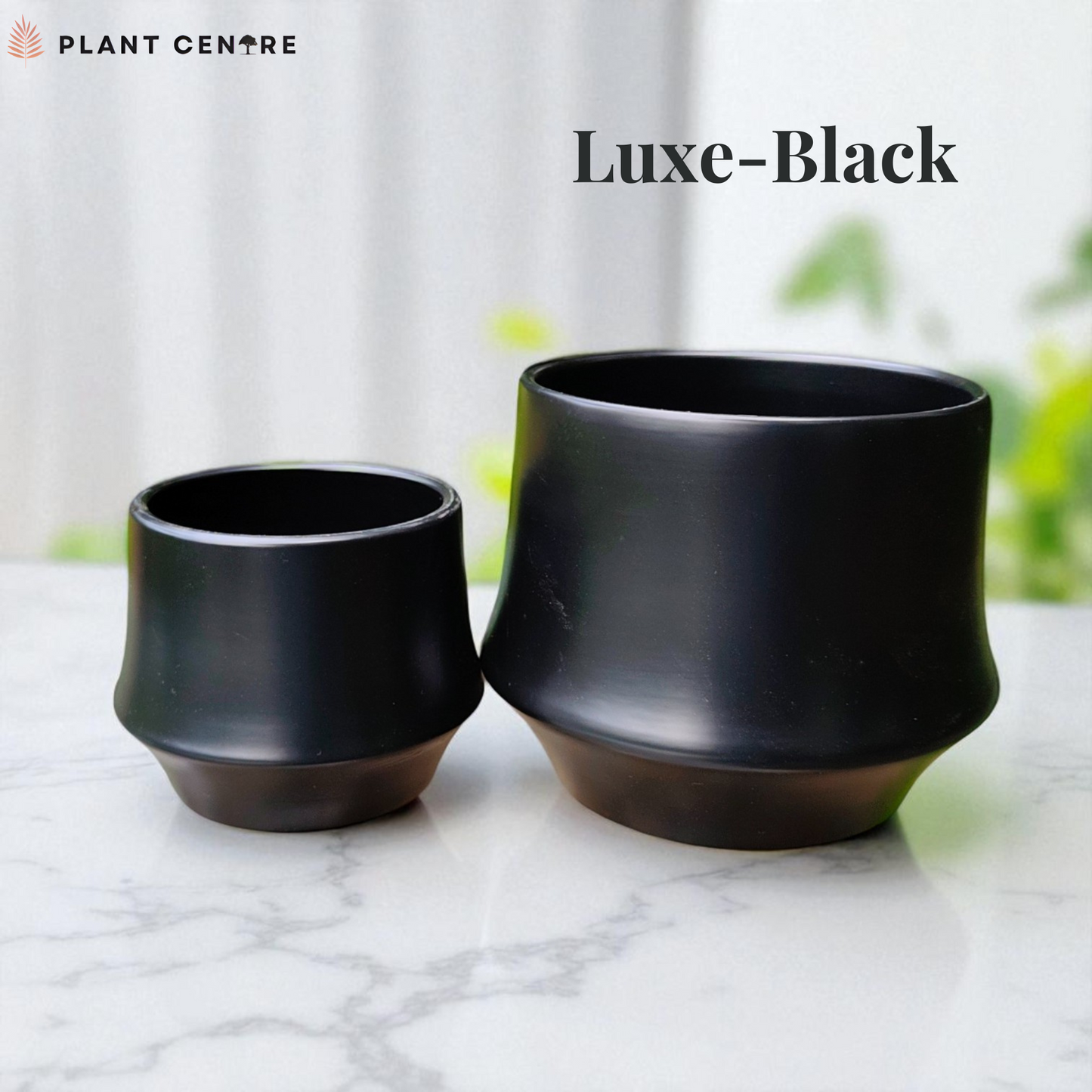Two black plant pots on a marble surface with 'Plant Centre' branding.